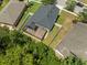 Aerial view of home with screened-in lanai and fenced yard, surrounded by green landscaping at 12055 Colony Lakes Blvd, New Port Richey, FL 34654