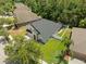 Aerial view displays a well-manicured lawn and a screened-in lanai of a two-story home at 12055 Colony Lakes Blvd, New Port Richey, FL 34654