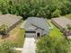 Overhead view shows a home with fenced backyard and well-kept landscaping in a tree-lined community at 12055 Colony Lakes Blvd, New Port Richey, FL 34654