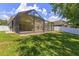 Green backyard with screen enclosed patio at 12055 Colony Lakes Blvd, New Port Richey, FL 34654