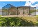 Exterior backyard featuring a screen enclosed patio at 12055 Colony Lakes Blvd, New Port Richey, FL 34654