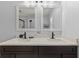 Bathroom featuring double sinks, a white countertop, dark cabinetry, and modern faucets at 12055 Colony Lakes Blvd, New Port Richey, FL 34654
