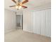 Bedroom featuring a ceiling fan and a large closet with white doors at 12055 Colony Lakes Blvd, New Port Richey, FL 34654