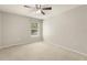 Bedroom featuring a ceiling fan and a window with views of green trees at 12055 Colony Lakes Blvd, New Port Richey, FL 34654