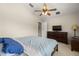 Bedroom featuring a ceiling fan, a window, and a sizable bed with blue pillows at 12055 Colony Lakes Blvd, New Port Richey, FL 34654