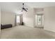 Bright bedroom featuring neutral walls, plush carpeting, and a ceiling fan at 12055 Colony Lakes Blvd, New Port Richey, FL 34654