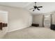 Spacious bedroom with neutral walls, plush carpeting, and a ceiling fan at 12055 Colony Lakes Blvd, New Port Richey, FL 34654
