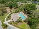 Community pool area with palm trees, well-kept landscaping, and lounge chairs for residents at 12055 Colony Lakes Blvd, New Port Richey, FL 34654