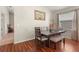 Bright dining area with wood floors, a dark wood table with bench, and a large window at 12055 Colony Lakes Blvd, New Port Richey, FL 34654