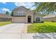 Charming two-story home with a well-manicured lawn, attached garage, and inviting entryway at 12055 Colony Lakes Blvd, New Port Richey, FL 34654