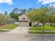 Well-maintained two-story home with manicured lawn, brick accents, and a two-car garage at 12055 Colony Lakes Blvd, New Port Richey, FL 34654