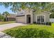 Lovely home featuring a two-car garage, manicured lawn, and welcoming front entrance at 12055 Colony Lakes Blvd, New Port Richey, FL 34654