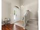 Elegant foyer with hardwood floors, staircase, and a view of the front door and entryway at 12055 Colony Lakes Blvd, New Port Richey, FL 34654