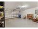 Spacious garage with epoxy flooring, open door, and ample room for parking and storage at 12055 Colony Lakes Blvd, New Port Richey, FL 34654