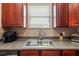 Close up of a modern kitchen sink under window with lots of storage at 12055 Colony Lakes Blvd, New Port Richey, FL 34654