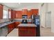 A spacious kitchen featuring an island, stainless steel appliances, and lots of cabinet storage at 12055 Colony Lakes Blvd, New Port Richey, FL 34654