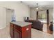 Open concept living area featuring kitchen island, ceiling fan, and glass doors to the outdoor deck at 12055 Colony Lakes Blvd, New Port Richey, FL 34654
