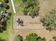 Aerial view of a playground with climbing equipment, swings, and mature trees at 12055 Colony Lakes Blvd, New Port Richey, FL 34654