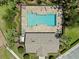 Aerial view of a community pool area with lounge chairs and well-maintained landscaping at 12055 Colony Lakes Blvd, New Port Richey, FL 34654