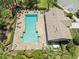 Overhead shot of a beautiful community pool with a spacious sundeck and surrounding landscaping at 12055 Colony Lakes Blvd, New Port Richey, FL 34654