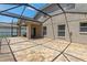 Exterior view of a screened patio area with brick flooring connected to the house at 12055 Colony Lakes Blvd, New Port Richey, FL 34654