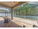Spacious screened patio with brick flooring and outdoor seating, perfect for enjoying the outdoors at 12055 Colony Lakes Blvd, New Port Richey, FL 34654