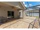 Large screened patio with brick flooring, ceiling fan, and view of the backyard at 12055 Colony Lakes Blvd, New Port Richey, FL 34654