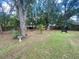 Spacious backyard with bird bath and small palm tree at 12090 Stoneville Ct, Spring Hill, FL 34609