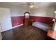 Bedroom with two tone walls, ceiling fan, window, and laminate flooring at 12090 Stoneville Ct, Spring Hill, FL 34609