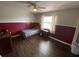 Bedroom with two tone walls, ceiling fan, window, and laminate flooring at 12090 Stoneville Ct, Spring Hill, FL 34609