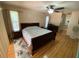 Spacious bedroom with hardwood floors, ceiling fan and a matching furniture set at 12090 Stoneville Ct, Spring Hill, FL 34609