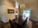 Formal dining area featuring a chandelier and a large table with seating for six at 12090 Stoneville Ct, Spring Hill, FL 34609