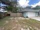 Exterior view of home with a garage and fenced yard at 12090 Stoneville Ct, Spring Hill, FL 34609