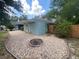 Rear exterior view of the home with landscaping, stone and a fence at 12090 Stoneville Ct, Spring Hill, FL 34609