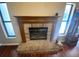 A traditional brick fireplace with a wooden mantel and adjacent windows at 12090 Stoneville Ct, Spring Hill, FL 34609