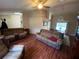 Open living space showcasing hardwood floors, comfortable couches, and dining area at 12090 Stoneville Ct, Spring Hill, FL 34609