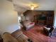 Open-concept living room and dining area with hardwood floors and vaulted ceilings at 12090 Stoneville Ct, Spring Hill, FL 34609
