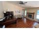 Spacious living room featuring a brick fireplace, vaulted ceilings, and wood-look floors at 12090 Stoneville Ct, Spring Hill, FL 34609