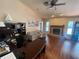 Comfortable living room with vaulted ceilings, a brick fireplace, and a home office area at 12090 Stoneville Ct, Spring Hill, FL 34609