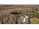 Aerial view features a pond surrounded by mature trees and the community's building exteriors and carports at 12155 Environmental Dr # 8, New Port Richey, FL 34654