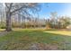 Picturesque backyard with a tranquil pond, bordered by mature trees and a well-maintained lawn at 12155 Environmental Dr # 8, New Port Richey, FL 34654