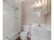 Bathroom featuring a vanity with a sink, a toilet, and a shower with tile walls and a shower head at 12155 Environmental Dr # 8, New Port Richey, FL 34654