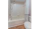 A clean bathroom features a shower over tub and neutral tiling at 12155 Environmental Dr # 8, New Port Richey, FL 34654