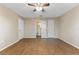 Large bedroom features wood-look flooring, neutral walls and doors leading to the en-suite bathroom and closet at 12155 Environmental Dr # 8, New Port Richey, FL 34654