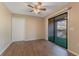 A bright bedroom with a ceiling fan and sliding doors to an outdoor space at 12155 Environmental Dr # 8, New Port Richey, FL 34654
