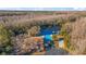 Aerial view of neighborhood pool, lake, and forest at 12155 Environmental Dr # 8, New Port Richey, FL 34654