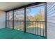 An enclosed porch overlooks a beautiful green lawn, providing additional outdoor living space at 12155 Environmental Dr # 8, New Port Richey, FL 34654