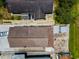 Top-down aerial of single-Gathering homes, displaying roofs and surrounding yards, and a car parked in front at 124 Athens St, Tarpon Springs, FL 34689