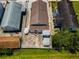 Aerial view of a property showing the rooftop, backyard, and surrounding buildings, ideal for assessing layout and space at 124 Athens St, Tarpon Springs, FL 34689