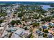 An aerial view of a neighborhood with lush trees, streets, and some visible water features, offering a serene living environment at 124 Athens St, Tarpon Springs, FL 34689